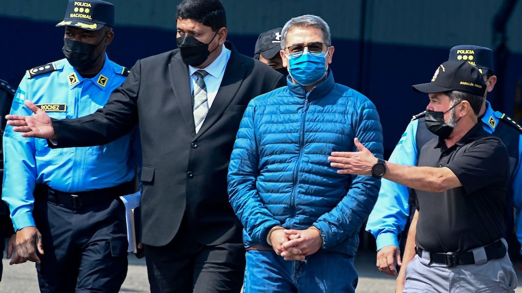 Honduras’ former president Juan Orlando Hernandez (second from right) is escorted towards a plane of the US drug enforcement agency during his extraditaton to the US, in Tegucigalpa on April 21st. Photograph: Orlando Sierra/AFP via Getty