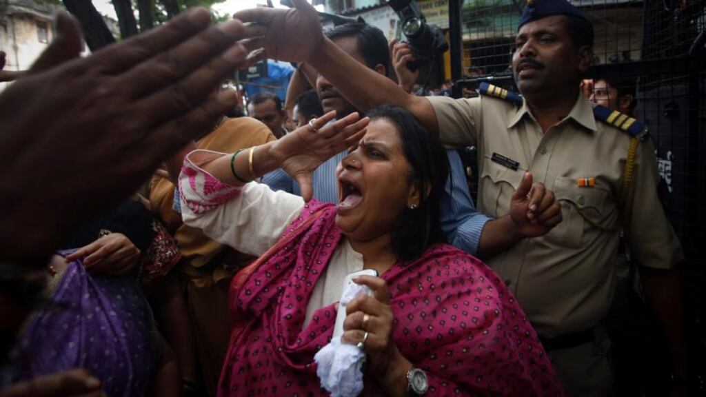 An activist shouts slogans during a protest over the rape of a photo journalist by five men inside an abandoned textile mill, in Mumbai on Thursday. Photograph: Reuters
