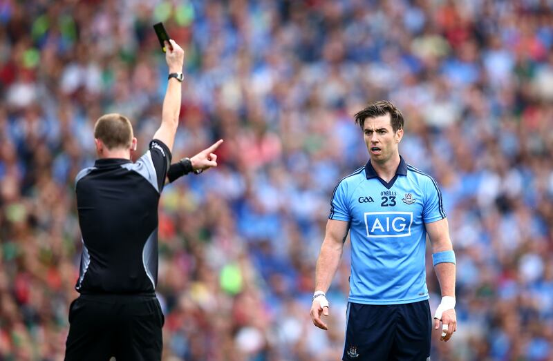 Referee Joe McQuillan shows Michael Darragh Macauley of Dublin a black card in the 49th minute of the All-Ireland semi-final at Croke Park. You have to learn to expect the unexpected and react to it on the hoof. Photograph: Cathal Noonan/Inpho