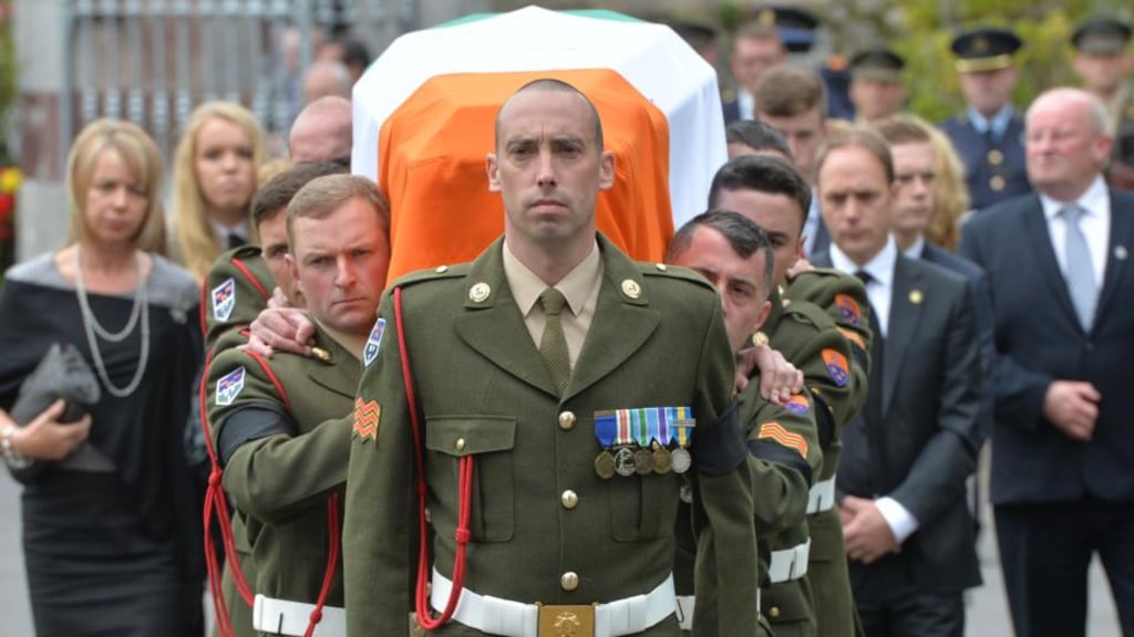The remains of Commandant Thomas Kent before the remains are carried into St. Nicholas’ church, Castlelyons, Co Cork by Defence Forces Pall Bearers followed by Nora Riordan (grand niece), Kathleen Kent (niece), Prudence Riordan (niece) and Michael Riordan (grand nephew) during the reinternment state funeral.  Photograph: Alan Betson