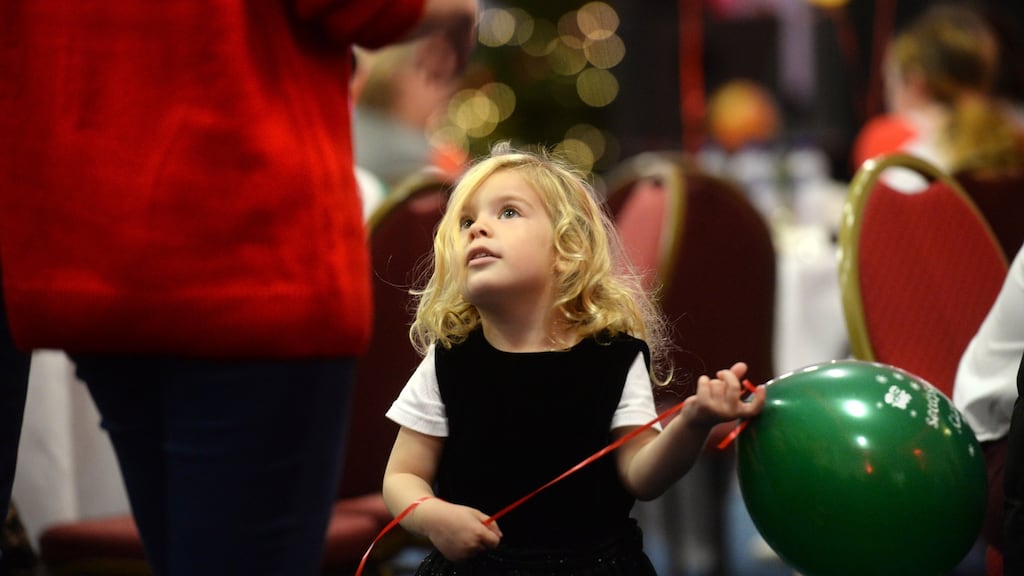 Dragos Evelyn Demisa Juditha (4), playing with a volunteer at the Knights of Columbanus Christmas dinner, in the RDS Dublin. Photograph: Dara Mac Dónaill / The Irish Times