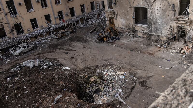 A crater yawns in the courtyard of the destroyed Kharkiv Regional State Administration building in Kharkiv, Ukraine, after Russian shelling. Photograph: Chris McGrath/Getty