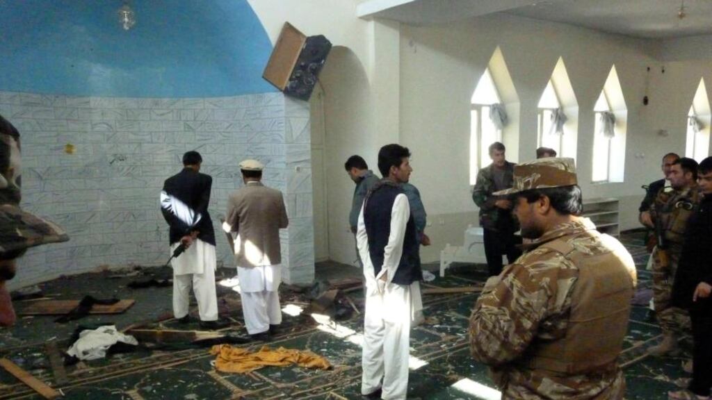 Afghan police and officials examine the mosque in Puli Alam, Logar province, where a bomb hidden in the base of a microphone killed governor Arsala Jamal yesterday. Photograph: Ahsanullah Majuze/AP