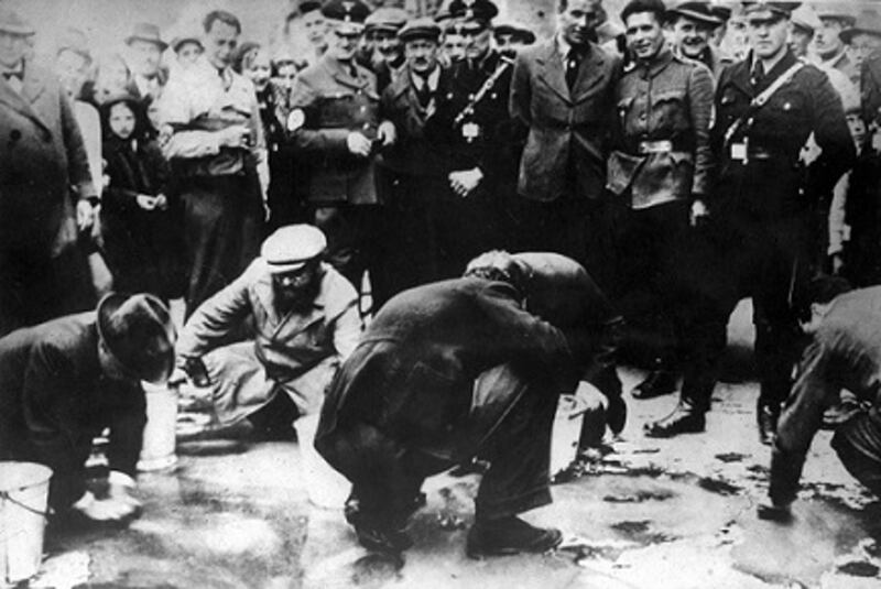 Jews are forced to scrub streets and pavements in Vienna in 1938.