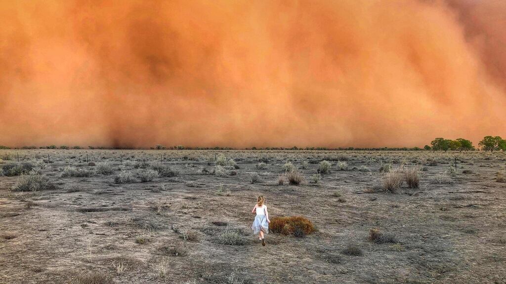 A handout photo courtesy of Marcia Macmillan shows a child in front of a dust storm in Mullengudgery in New South Wales. Photograph: Getty