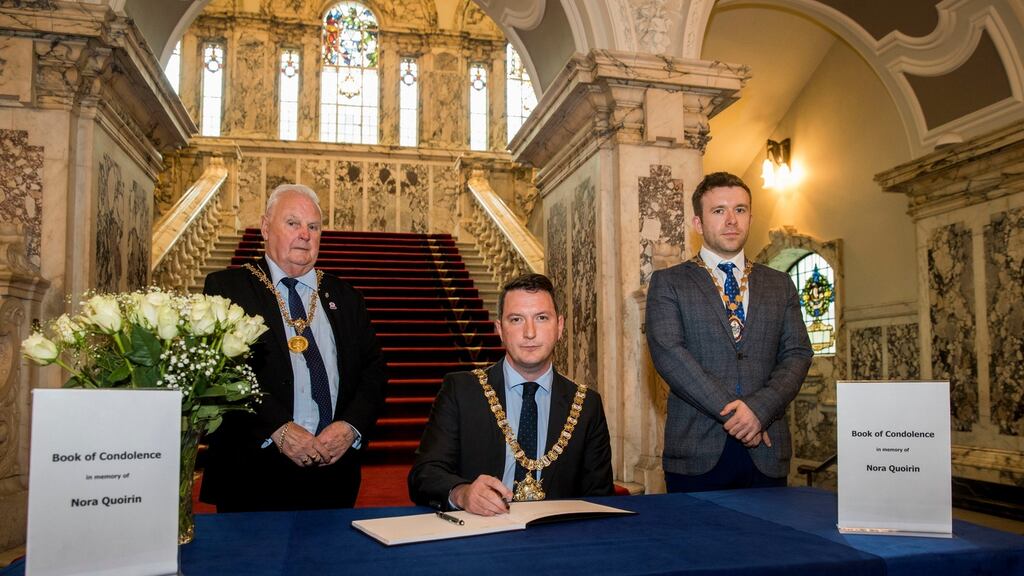 Belfast lord mayor John Finucane, centre, with Belfast high sheriff Tommy Sandford, left, and deputy lord mayor Peter McReynolds during the signing of the book of condolence at Belfast City Hall. Photograph: Liam McBurney/PA Wire