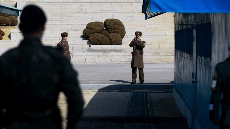 A North Korean soldier (C) takes pictures during the visit of Julie Bishop (not pictured), Australian Minister for Foreign Affairs,at the (DMZ) in the border village of Panmunjom, South Korea in February. Photograph: Kim Hee-Chul/EPA