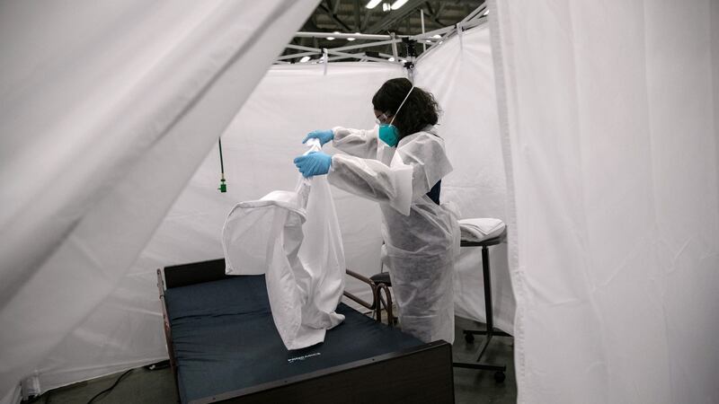 A nurse makes a bed in a Covid-19 isolation bay at the Austin Convention Center in Austin, Texas. Photograph: John Moore/Getty