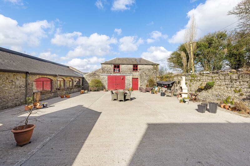 A sunny courtyard lies to the rear of the house