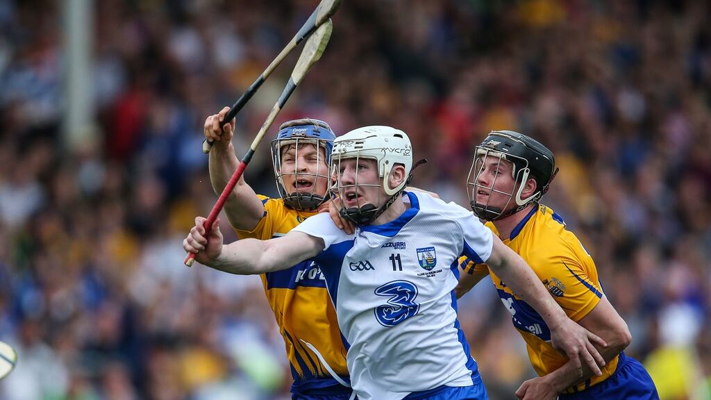 Clare’s Podge Collins  tackles Waterford’s Shane Bennett during the league final replay. Photograph: Cathal Noonan/Inpho