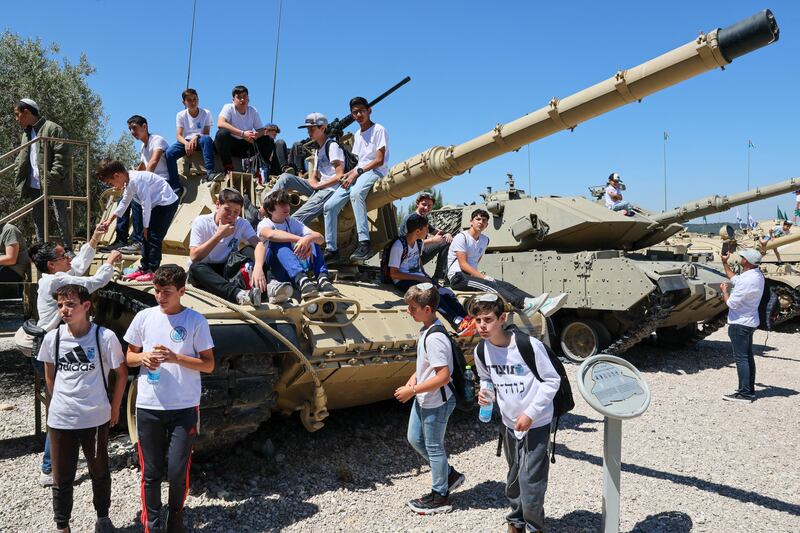 Children sit on a tank at the Armoured Corps Memorial during a ceremonoy to observe Memorial Day in Latrun, Israel. PhotographL Jack Guez/AFP via Getty Images