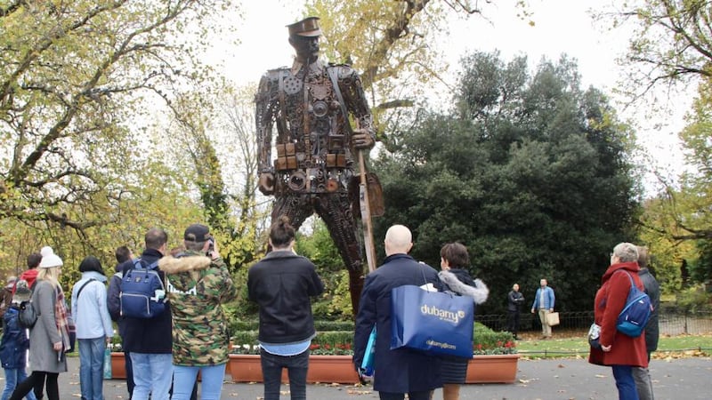 People take in the ‘Haunting Soldier’ at St Stephen’s Green, Dublin, on Saturday. Sabina Purcell, who organised the work’s installation in Dublin, said: “There are hordes of people around it taking photos. I’m so moved by the respect being shown to it by members of the public.” Photograph: Ronan McGreevy