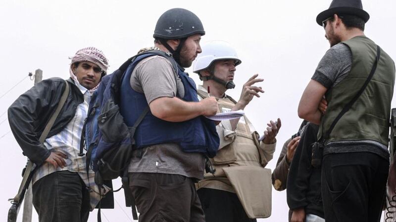 American journalist Steven Sotloff (Centre with black helmet) talks to Libyan rebels on the Al Dafniya front line, 25 km west of Misrata, Libya in June 2011. Photograph: Etienne de Malglaive/Getty Images