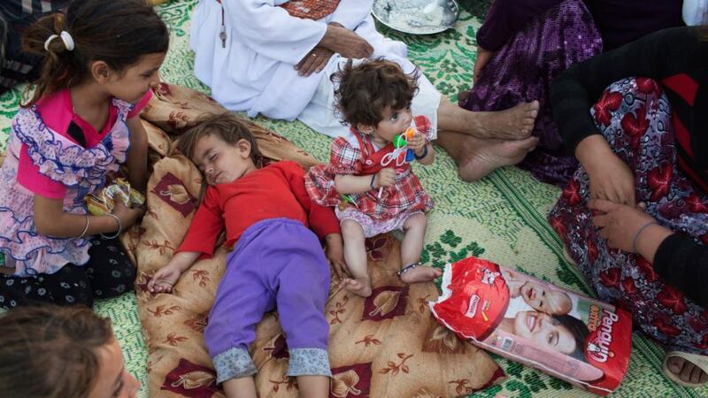 Yazidi children rest at a camp of refugees fleeing from Islamic State forces, by a roadside in Dohuk, Iraq yesterday. Photograph: Adam Ferguson/The New York Times