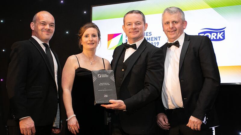 Liam Smith, Sales Director, Tork an Essity brand, presents the Total FM Service Provider of the Year award to Aramark Workplace Solutions Team.