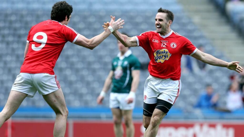 Tyrone's Mark Donnelly celebrates scoring his sides second goal against Kildare with Seán Cavanagh. Photograph: Donall Farmer/Inpho