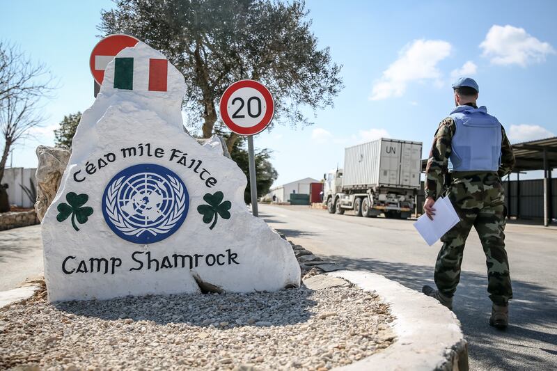 A peacekeeper walks past a sign greeting new arrivals to Camp Shamrock in south Lebanon. Photograph: Sally Hayden