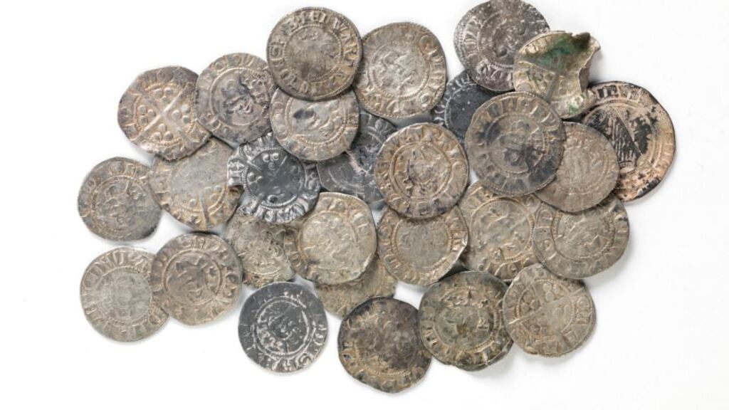 Treasure hunters using metal detectors are believed to have been behind the removal of nearly 900 artefacts from Ireland that have been recovered in the UK. Pictured are 28 medieval silver coins which were recovered by Norfolk Constabulary. Photograph: Ciara Wilkinson / National Museum of Ireland.