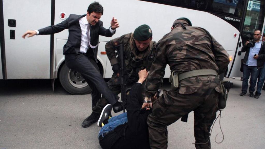 One of the photographs capturing the moment when a protester was kicked by Yusuf Yerkel (left), adviser to Turkey’s prime minister Tayyip Erdogan, as Special Forces police officers detained the activist during a protest against Mr Erdogan’s visit to Soma, a district in Turkey’s western province of Manisa, after the minding disaster there earlier this month.  Photograph: Mehmet Emin/Reuters