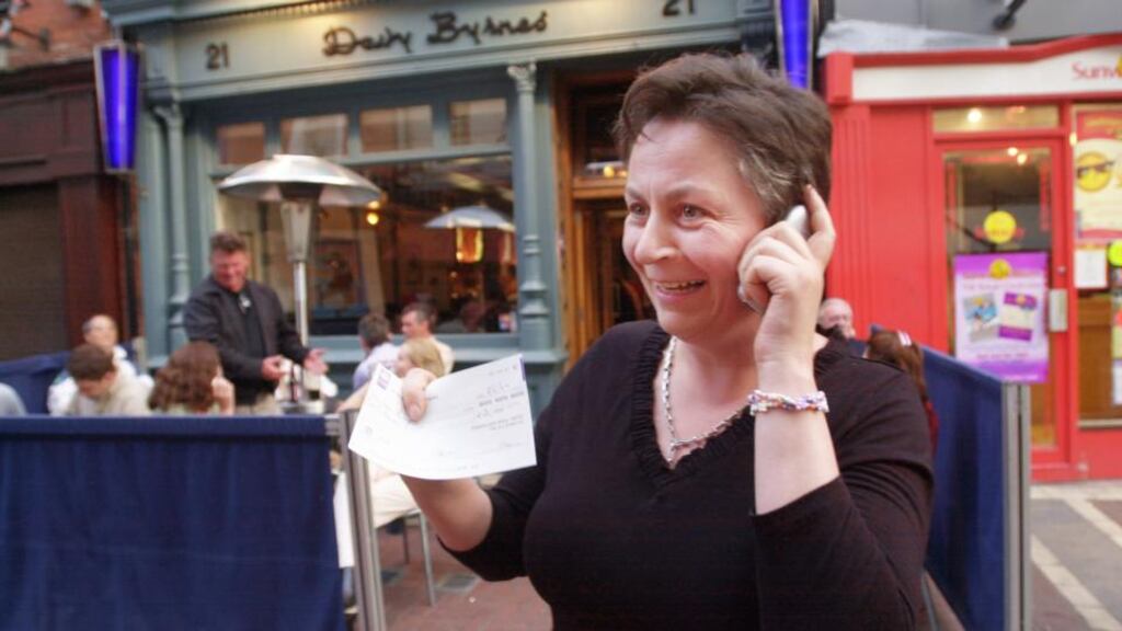 Anne Enright rings home to give her husband the news that she had just been awarded the Davy Byrnes Irish Writing Award 2004. Photograph: Bryan O’Brien