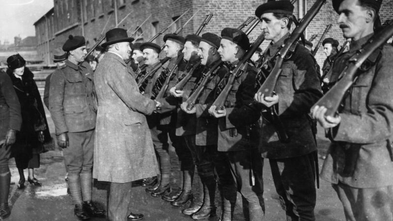 January 1921: Sir Hamar Greenwood inspects a group of Black and Tans, an armed auxiliary force of the RIC. Photograph: Topical Press Agency/Getty Images