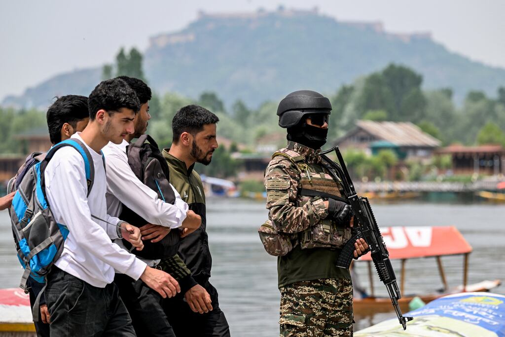 An Indian paramilitary personnel stands guard along the banks of Dal Lake in Srinagar, Kashmir, on Tuesday. Photograph: Sajjad Hussain/AFP via Getty Images