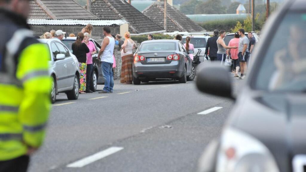 Emergency services and relatives ouside the O’Driscoll family home where nine-year-old twins Patrick and Tom died yesterday. Photograph: Daragh Mc Sweeney/Provision