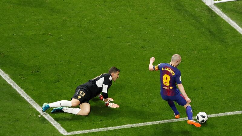 Andres Iniesta scores Barcelona’s fourth goal in their Copa del Rey victory over Sevilla. Photograph: Juan Carlos Hidalgo/EPA