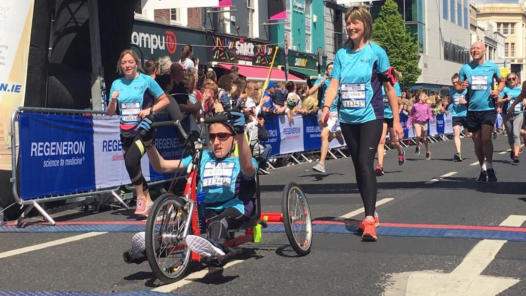 Sean Byrnes (14), from Caherconreafy, Co Limerick, completing Sunday’s Great Limerick Run 10km event, with his mother Fiona Byrnes. Photograph: David Raleigh
