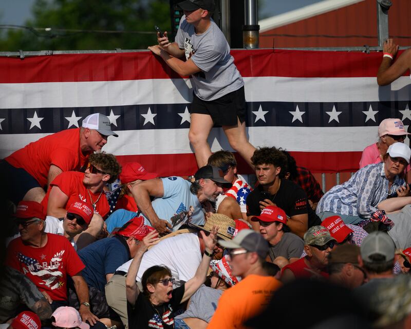 Attendees duck from gunfire at a campaign rally for Donald Trump in Butler, Pennsylvania. Photograph: Jeff Swensen/Getty Images