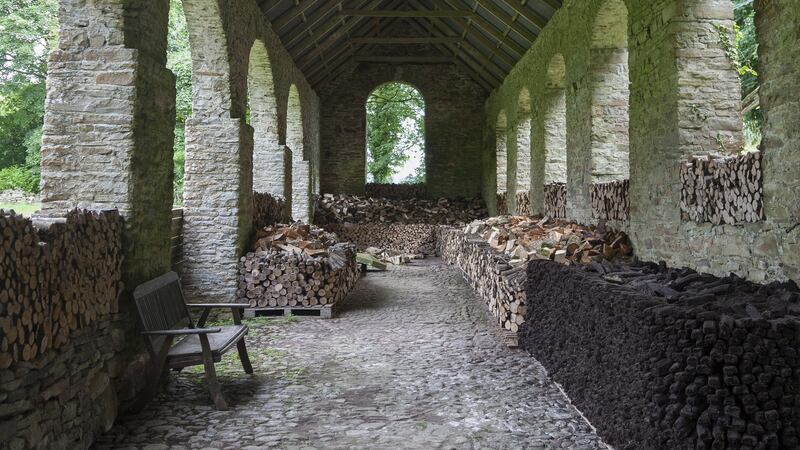 The turf barn with wood stacks at Roundwood House, Mountrath, Co Laois.  Photograph: James Fennell