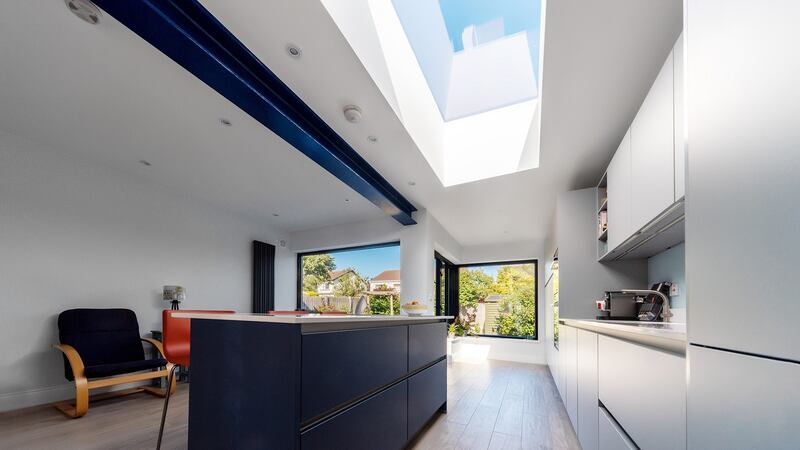 An exposed support beam, a rolled steel joist (RSJ), is painted blue.