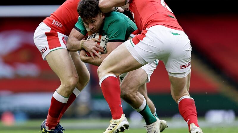 Wales’ Dan Biggar and George North tackle Hugo Keenan. Photo: Laszlo Geczo/Inpho