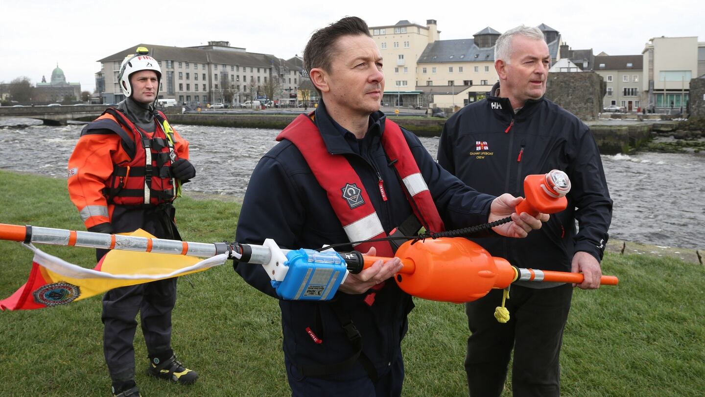 Darren Reynolds, sub officer, Galway Fire Station (left), and Mike Swan, Galway RNLI Lifeboat operations manager, with the Dan Buoy. Behind is John McGauley of Galway Fire Brigade. Photograph: Joe O’Shaughnessy.