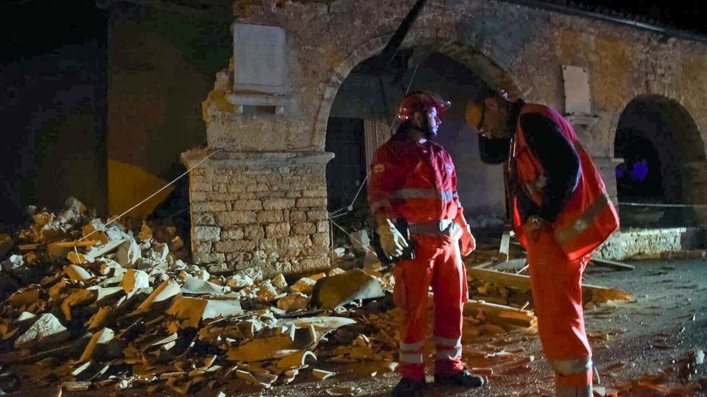 Rescuers stand by rubble in the village of Visso, central Italy. Photograph: Matteo Crocchioni/ANSA via AP