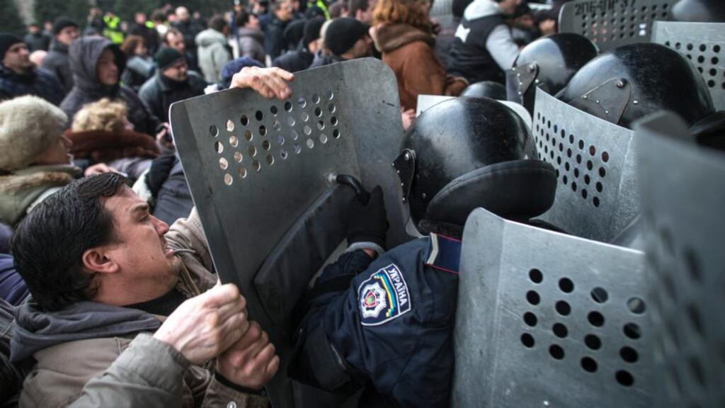 Pro-Russian protesters clash with riot police outside the regional parliament building in Donetsk, Ukraine today. Photograph: Uriel Sinai/The New York Times