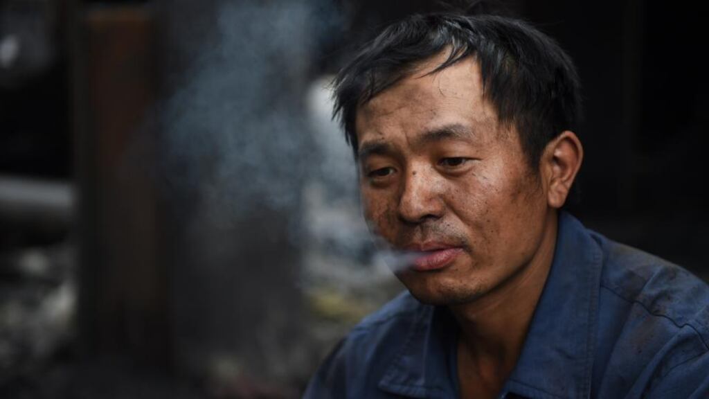 A worker smoking during a break at a demolition site in Beijing. Data shows that about 1.5 million people die from smoking-related diseases every year in China, where there are 300 million smokers. Photograph: Greg Baker/AFP/Getty Images