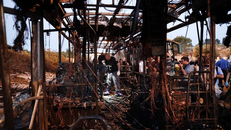 Israeli forensics search in the remains of burned-out a bus following an explosion in Jerusalem. Photograph: Thomas Coex/AFP/Getty Images