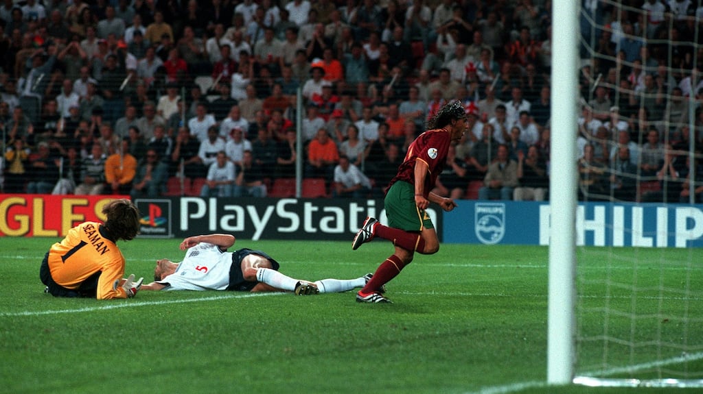 Portugal’s Nuno Gomes scores the winning goal past England goalkeeper David Seaman and Tony Adams during their Euro 2000 clash. Photo: Getty Images
