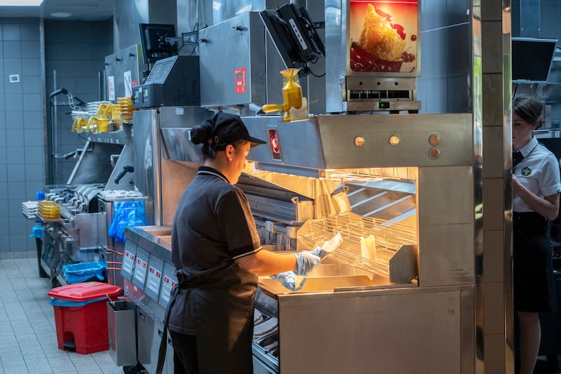 Kitchen staff work on orders. Photograph: Dmitry Serebryakov/AP