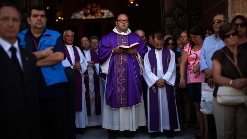 Priests and mourners await the arrival of the coffins of couple Antonio Reyes Asensio and Maria Rosa Quijano Fernandez, two of the victims of Wednesday’s train crash in Santiago de Compostela, outside Iglesia Mayor church in San Fernando, near Cadiz, southern Spain. Survivors and families of victims from Spain’s deadliest train crash in decades were desperate for answers as to why the eight-carriage, high-speed train derailed on a sharp bend, slamming into a concrete wall. Photograph: Jon Nazca/Reuters