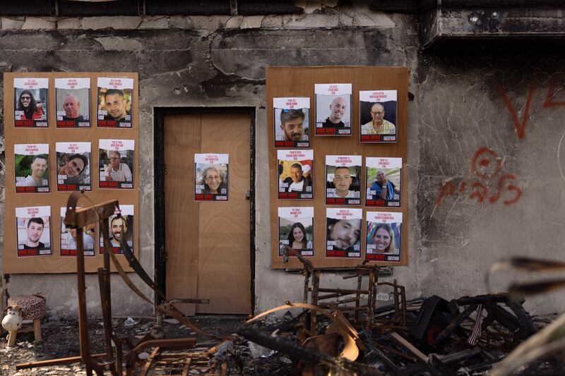 Photographs of Israeli hostages held by Hamas hang in a house in kibbutz Be'eri that was destroyedin the Hamas-led attack of October 7th.  Photograph:  Maja Hitij/Getty Images