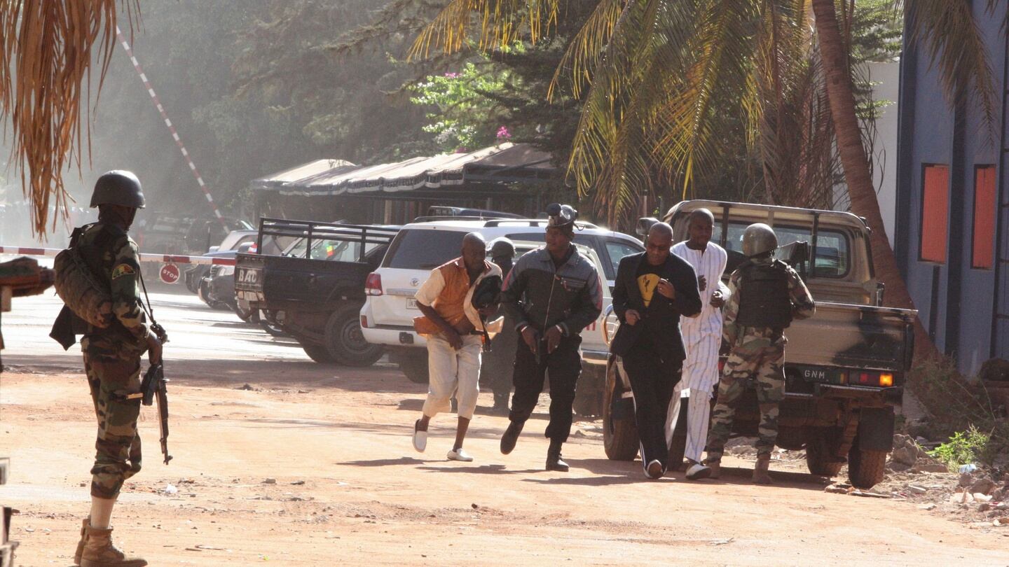 People run to flee from the Radisson Blu Hotel in Bamako, Mali. Photograph: Harouna Traore/AP Photo