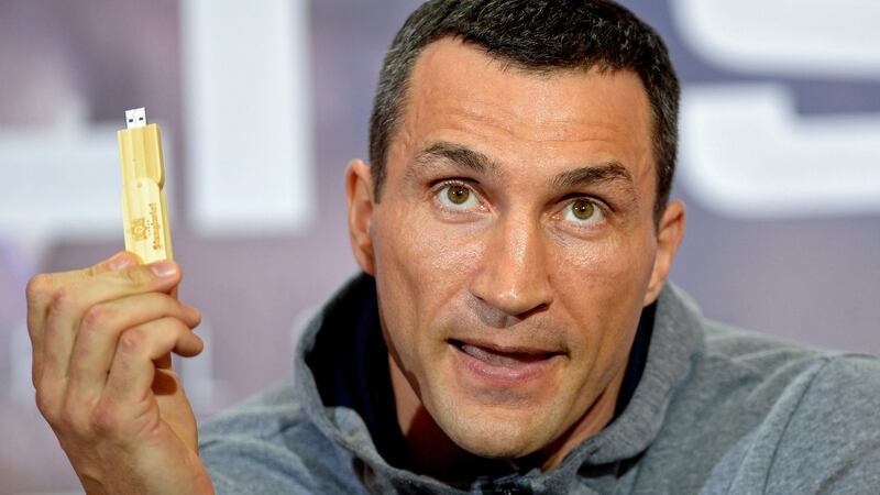 Klitschko holds a memory stick which has the prediction of the fight and that will be auctioned for his foundation afterwards. Photo: Gerry Penny/EPA