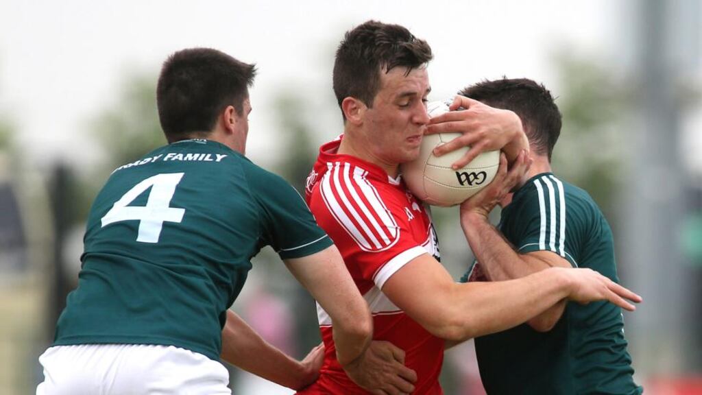 Derry’s Shane McGuigan tries to get through ’s Mick O’Grady and Eoin Doyle. Photograph: Lorcan Doherty/Inpho