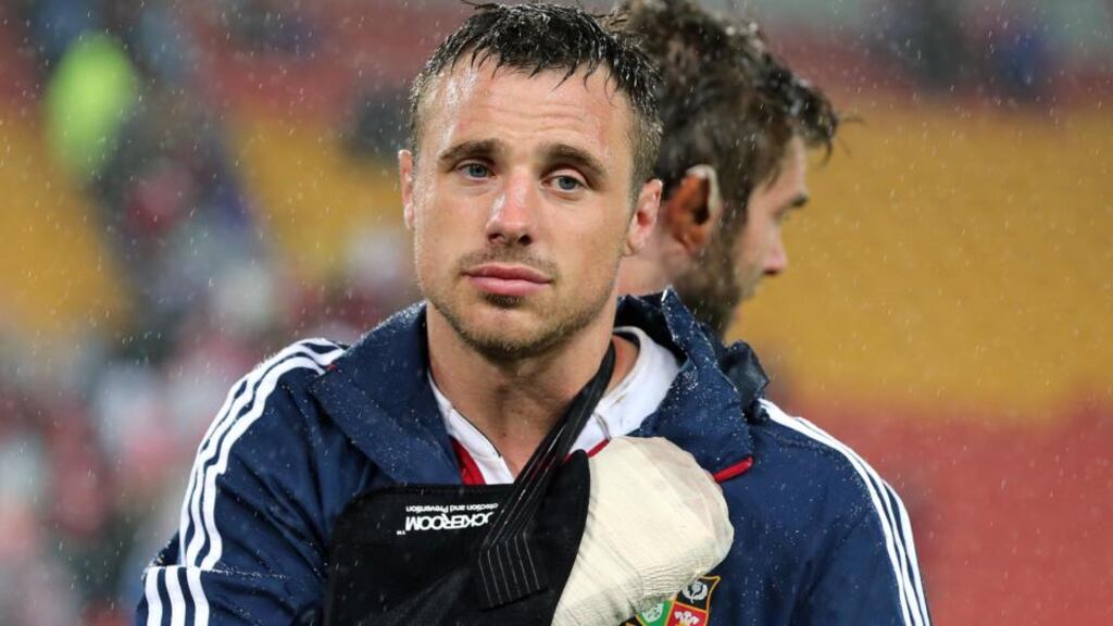 Tommy Bowe leaves the pitch with his right arm in a sling after breaking a bone in his hand during the Lions’ game against the Queensland Reds in Brisbane. Photograph: Dan Sheridan/Inpho