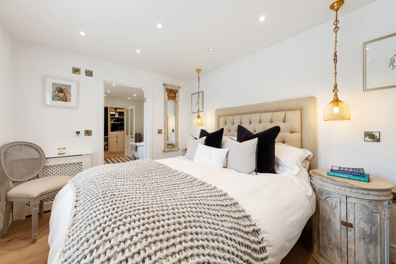 The principal bedroom benefits from cool feature pendant lights, a fully shelved dressing room and new bathroom.