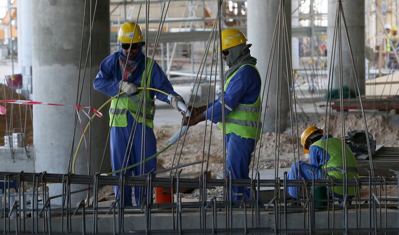 Migrant labourers work on a construction site  in Doha in 2013.  Photograph: Karim Jaafar/AFP/Getty Images)