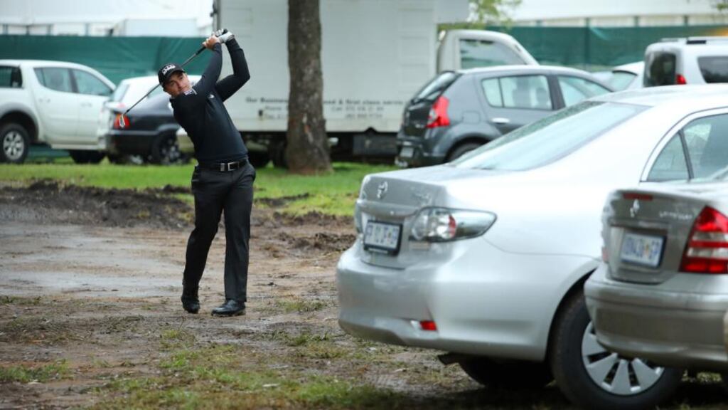 Paul Dunne plays from a car park during the weather-affected opening round of the Joburg Open. Photograph: Warren Little/Getty