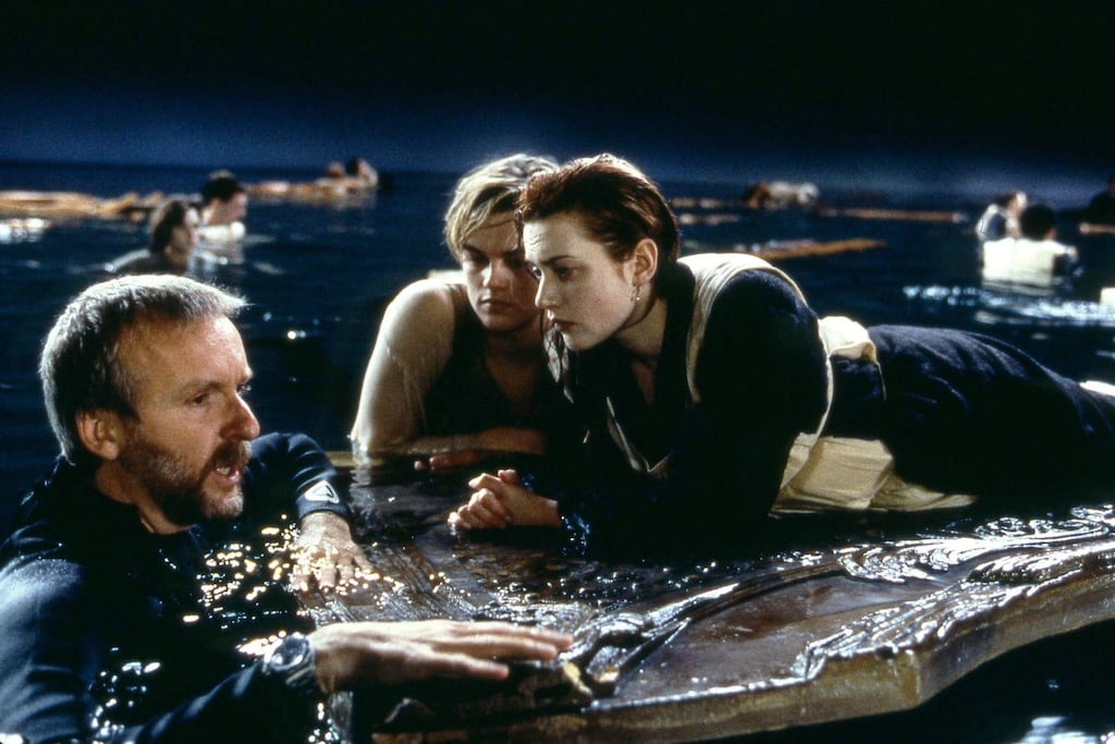 Titanic: director James Cameron with Leonardo DiCaprio and Kate Winslet during the filming of the 1997 movie's floating-door scene. Photograph: 20th Century Fox